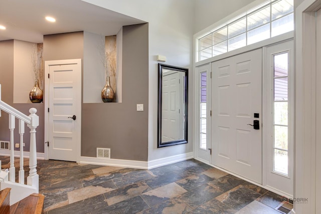 202 Dallas Dr, Bartlett, IL 60103 - entryway with stairway, stone tile flooring, plenty of natural light, a high ceiling, and recessed lighting