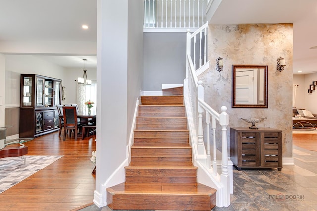202 Dallas Dr, Bartlett, IL 60103 - staircase featuring a chandelier, recessed lighting, and wood finished floors