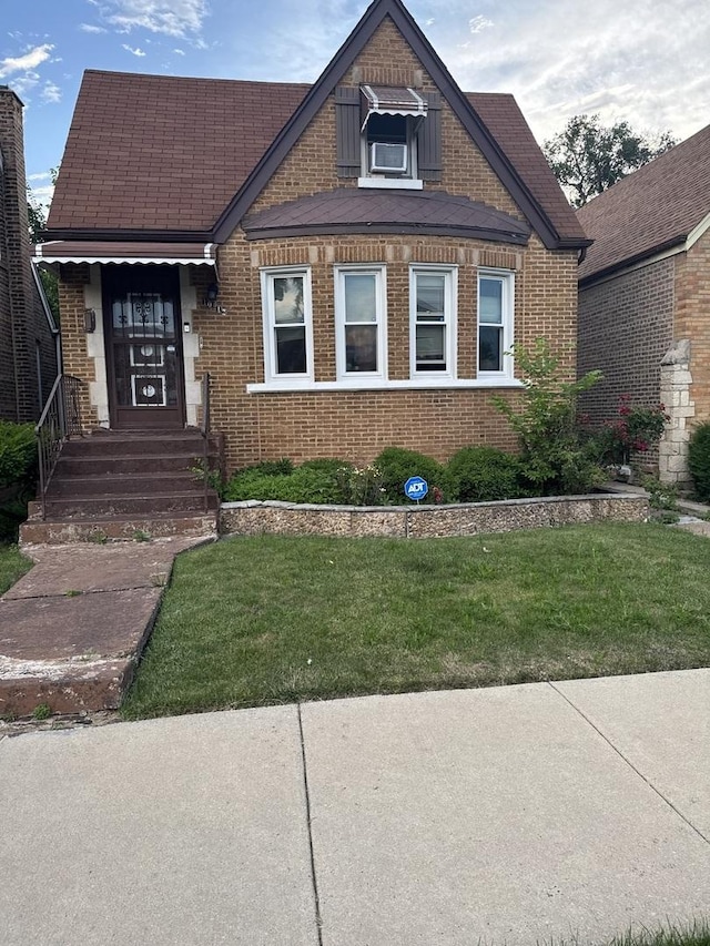 10212 S Prairie Ave, Chicago, IL 60628 - tudor house with brick siding and a front lawn