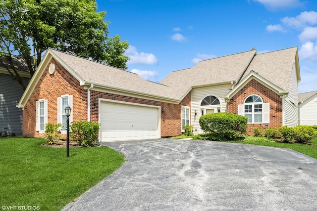 36230 N Old Creek Ct, Gurnee, IL 60031 - view of front of house featuring brick siding, driveway, an attached garage, roof with shingles, and a front lawn