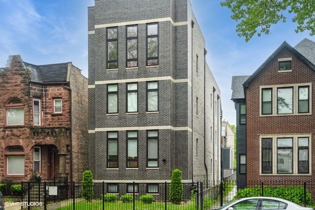 4730 S Champlain Ave Unit 3, Chicago, IL 60615 - view of front of property with a fenced front yard and brick siding