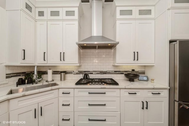 4730 S Champlain Ave Unit 3, Chicago, IL 60615 - kitchen featuring stainless steel appliances, wall chimney range hood, white cabinetry, and decorative backsplash