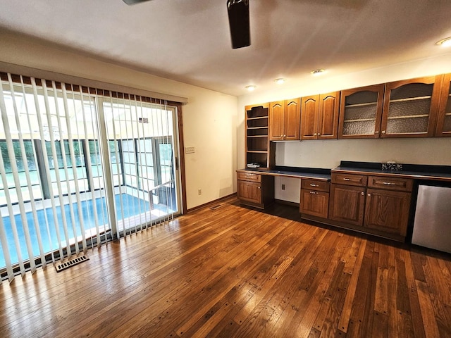9616 Zimmer Dr, Algonquin, IL 60102 - kitchen with dark wood finished floors, built in desk, dark countertops, and glass insert cabinets