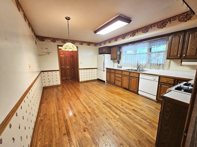 9616 Zimmer Dr, Algonquin, IL 60102 - kitchen featuring white appliances, light wood-style floors, wainscoting, decorative light fixtures, and light countertops