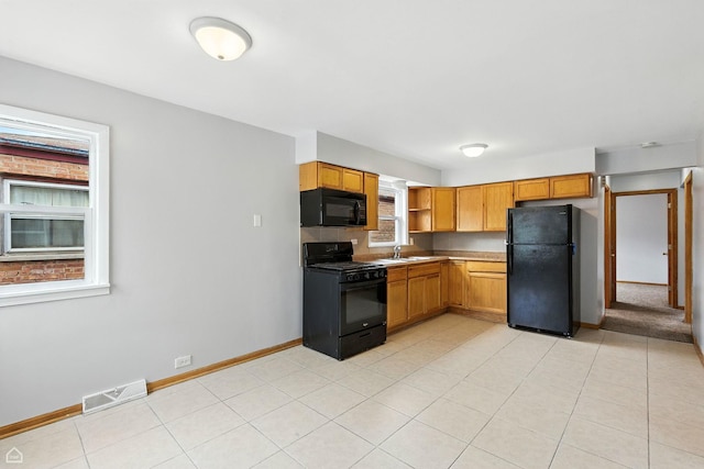 14526 Loomis Ave, Harvey, IL 60426 - kitchen featuring black appliances, open shelves, light countertops, and light tile patterned flooring