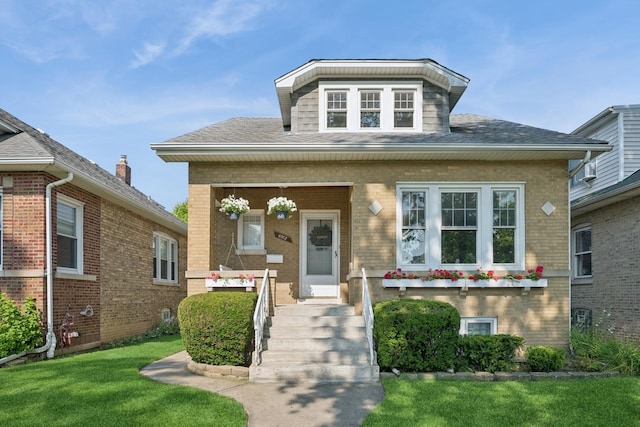 6912 N Osceola Ave, Chicago, IL 60631 - bungalow-style home with brick siding, a front yard, and roof with shingles