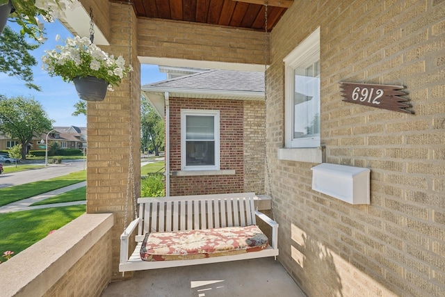6912 N Osceola Ave, Chicago, IL 60631 - view of exterior entry featuring a shingled roof and brick siding
