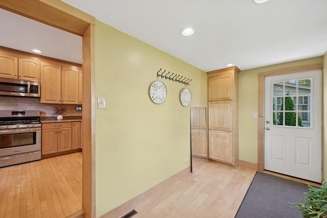6912 N Osceola Ave, Chicago, IL 60631 - kitchen with appliances with stainless steel finishes, light wood-type flooring, backsplash, recessed lighting, and light brown cabinetry