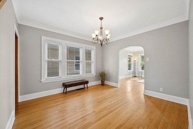 6912 N Osceola Ave, Chicago, IL 60631 - spare room with arched walkways, a chandelier, crown molding, and light wood-style flooring
