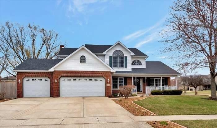 1019 James Pass, New Lenox, IL 60451 - traditional-style house featuring driveway, covered porch, brick siding, and an attached garage