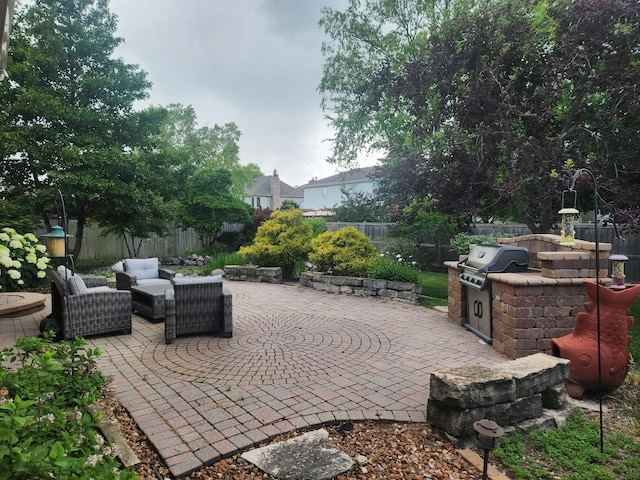 1019 James Pass, New Lenox, IL 60451 - fenced backyard featuring a patio area, an outdoor kitchen, and outdoor lounge area