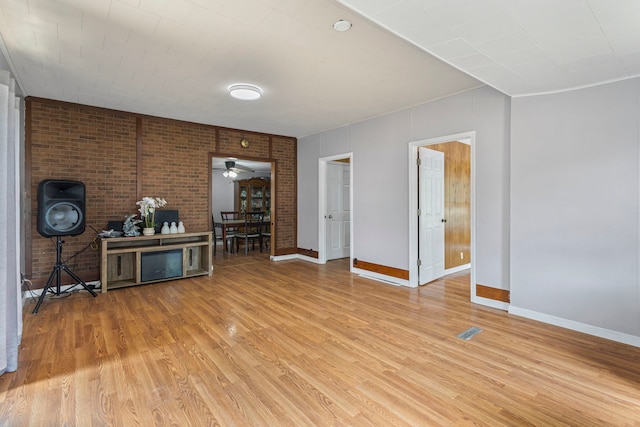 906 N State St, Marengo, IL 60152 - living room featuring light wood-type flooring and brick wall
