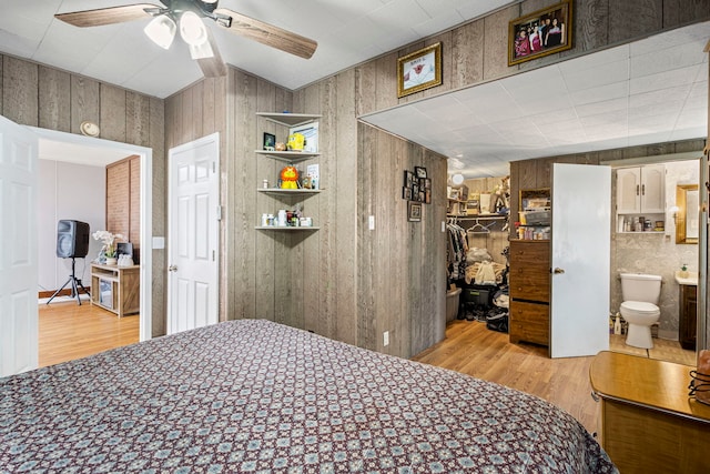 906 N State St, Marengo, IL 60152 - bedroom with wood finished floors, wood walls, a spacious closet, ensuite bathroom, and a closet