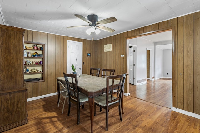 906 N State St, Marengo, IL 60152 - dining area featuring ceiling fan, wood finished floors, and wood walls