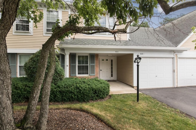 910 Persimmon Ln Unit B, Mount Prospect, IL 60056 - view of front of home featuring an attached garage, asphalt driveway, and roof with shingles