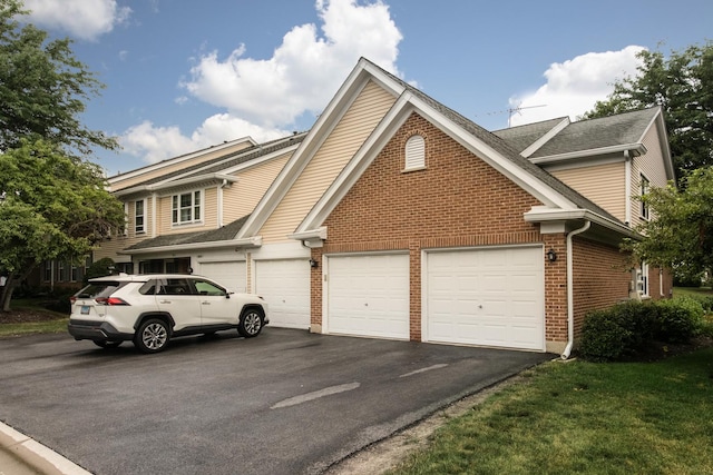 910 Persimmon Ln Unit B, Mount Prospect, IL 60056 - traditional-style home with driveway, brick siding, roof with shingles, and an attached garage