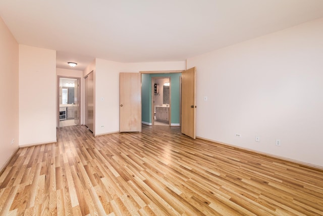 910 Persimmon Ln Unit B, Mount Prospect, IL 60056 - empty room with light wood finished floors and baseboards