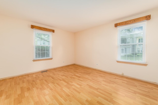 910 Persimmon Ln Unit B, Mount Prospect, IL 60056 - empty room featuring light wood-type flooring and baseboards