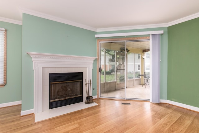 910 Persimmon Ln Unit B, Mount Prospect, IL 60056 - unfurnished living room with crown molding, wood finished floors, and a tiled fireplace