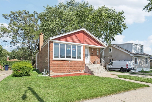 8753 S Troy Ave, Evergreen Park, IL 60805 - bungalow featuring brick siding, a front lawn, and a chimney