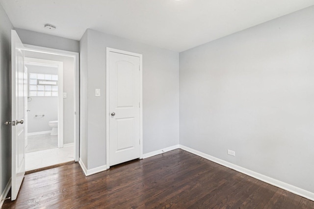 8753 S Troy Ave, Evergreen Park, IL 60805 - unfurnished bedroom with dark wood-type flooring and baseboards