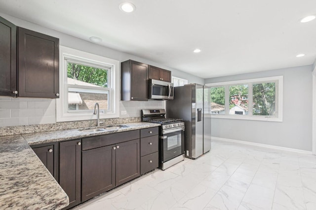 8753 S Troy Ave, Evergreen Park, IL 60805 - kitchen featuring appliances with stainless steel finishes, light marble finish floors, healthy amount of natural light, backsplash, and recessed lighting