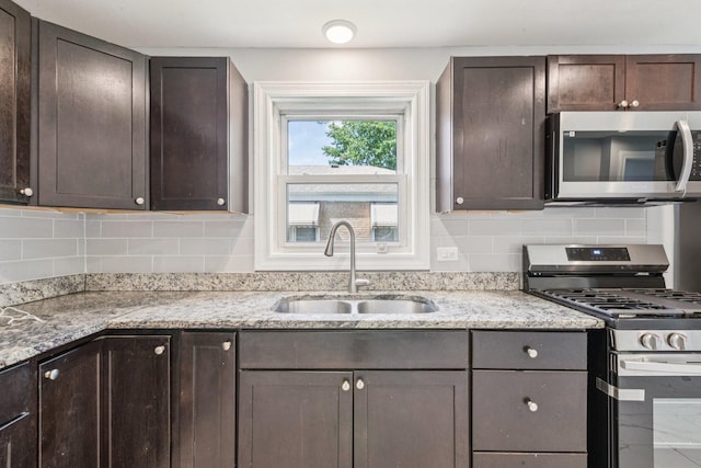 8753 S Troy Ave, Evergreen Park, IL 60805 - kitchen featuring stainless steel appliances, dark brown cabinetry, tasteful backsplash, and light stone counters