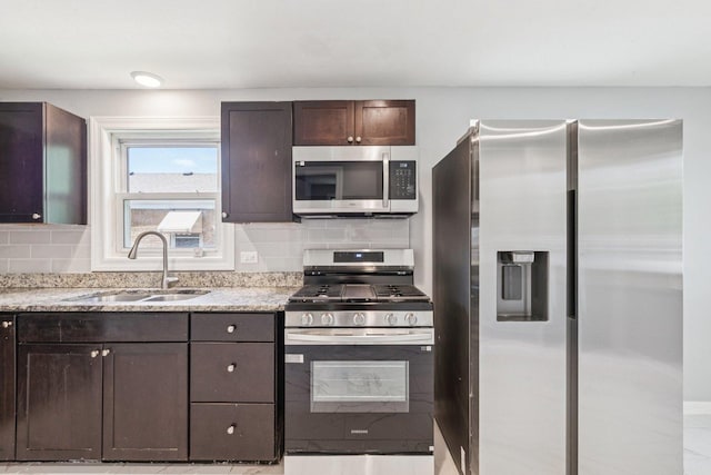 8753 S Troy Ave, Evergreen Park, IL 60805 - kitchen featuring appliances with stainless steel finishes, backsplash, dark brown cabinetry, and light stone countertops