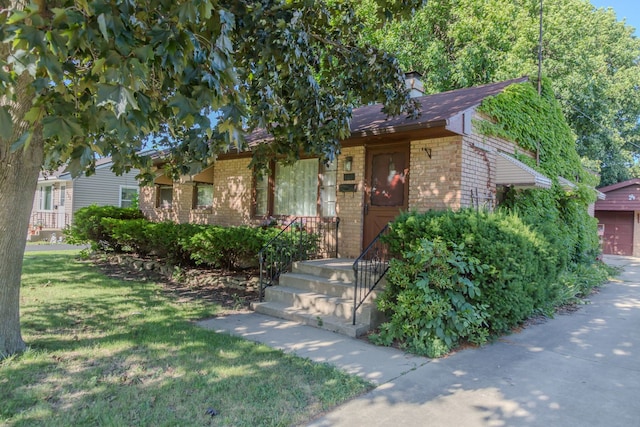 129 N Chase Ave, Bartlett, IL 60103 - obstructed view of property featuring brick siding, a chimney, and a front yard