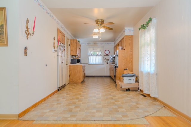 129 N Chase Ave, Bartlett, IL 60103 - kitchen featuring a ceiling fan, stainless steel oven, freestanding refrigerator, black microwave, and brown cabinets