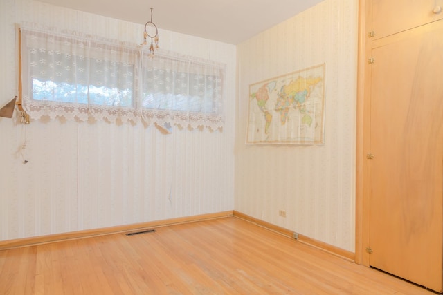 129 N Chase Ave, Bartlett, IL 60103 - unfurnished dining area featuring wood finished floors and wallpapered walls