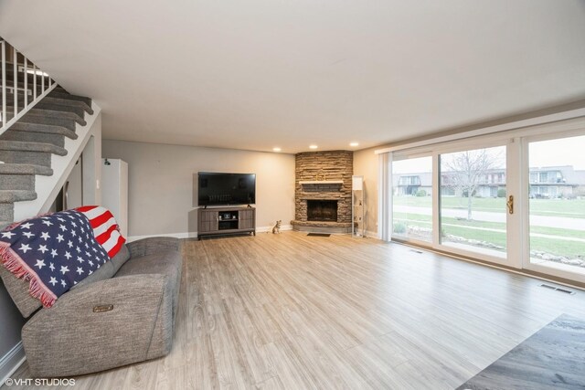 4 Cour La Salle Ct, Palos Hills, IL 60465 - living area with wood finished floors, a stone fireplace, stairway, and recessed lighting