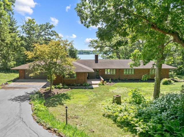 39081 N Sheridan Rd, Antioch, IL 60002 - ranch-style house with asphalt driveway, a front lawn, a chimney, and brick siding