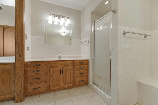 39081 N Sheridan Rd, Antioch, IL 60002 - bathroom with tile walls, a shower stall, vanity, tile patterned flooring, and wainscoting