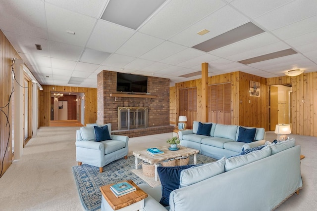 39081 N Sheridan Rd, Antioch, IL 60002 - carpeted living room with wood walls, a drop ceiling, and a brick fireplace