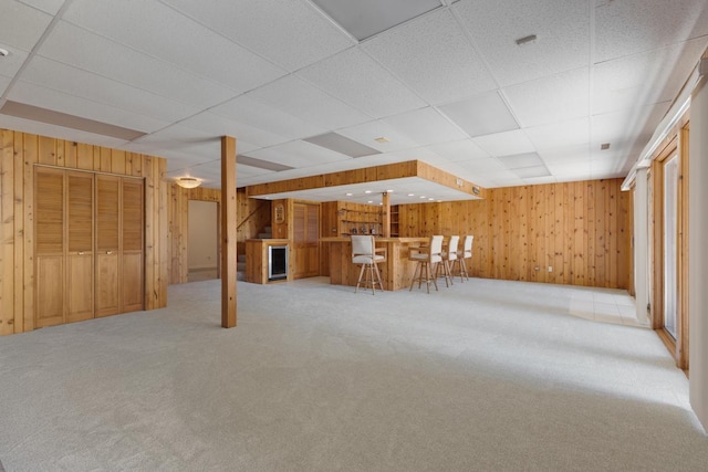 39081 N Sheridan Rd, Antioch, IL 60002 - finished basement featuring a dry bar, wood walls, carpet flooring, and a paneled ceiling
