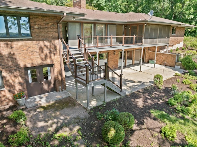 39081 N Sheridan Rd, Antioch, IL 60002 - back of property with a patio area, stairs, a chimney, and brick siding