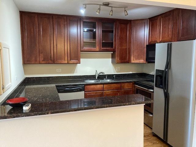 442 E Osage Ln Unit 3A, Palatine, IL 60067 - kitchen featuring stainless steel appliances, dark stone countertops, a peninsula, and glass insert cabinets