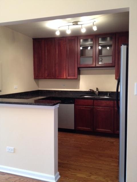 442 E Osage Ln Unit 3A, Palatine, IL 60067 - kitchen with freestanding refrigerator, dark countertops, dark wood-style flooring, dark brown cabinets, and dishwasher