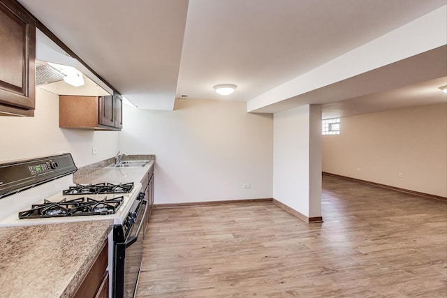 1927 Herbert Ave, Berkeley, IL 60163 - kitchen featuring black range with gas cooktop, light wood-style floors, light countertops, and exhaust hood