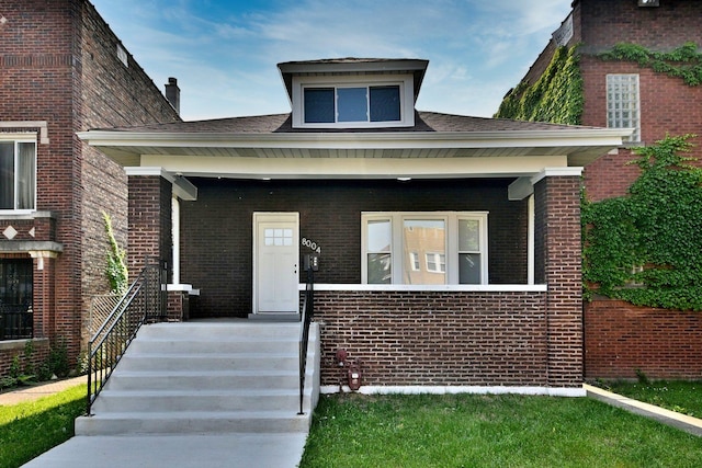8004 S Ada St, Chicago, IL 60620 - view of front facade featuring brick siding, covered porch, and a chimney