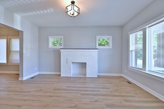 8004 S Ada St, Chicago, IL 60620 - unfurnished living room featuring light wood-style floors and a fireplace
