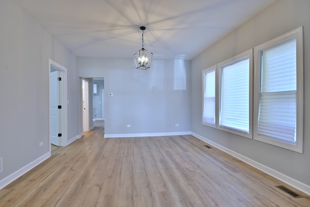 8004 S Ada St, Chicago, IL 60620 - spare room featuring a chandelier and light wood-style floors