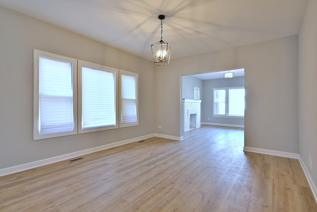8004 S Ada St, Chicago, IL 60620 - empty room with a chandelier and light wood-style floors