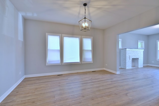 8004 S Ada St, Chicago, IL 60620 - unfurnished living room with a chandelier, wood finished floors, and a fireplace
