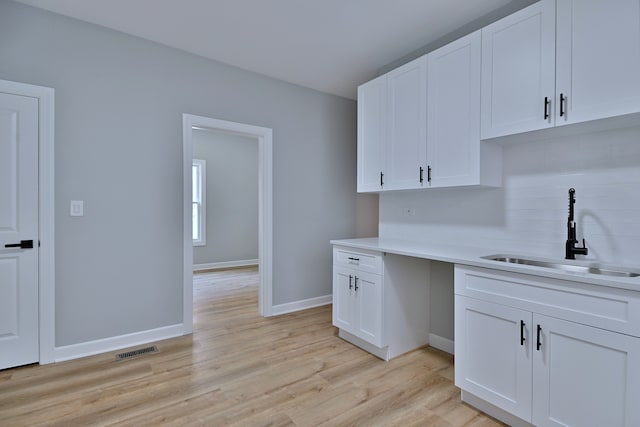 8004 S Ada St, Chicago, IL 60620 - kitchen with tasteful backsplash, white cabinets, light wood-style floors, and light countertops