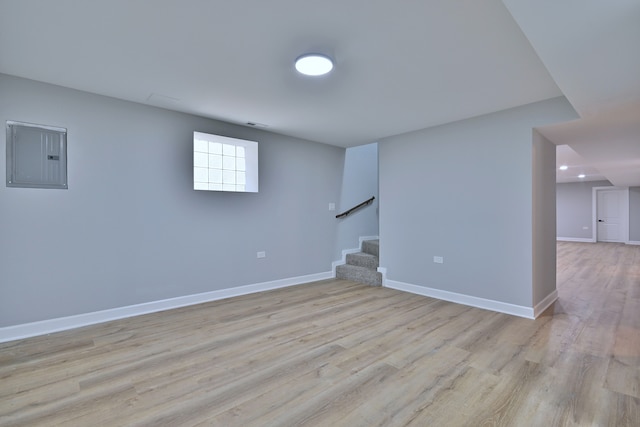 8004 S Ada St, Chicago, IL 60620 - basement featuring electric panel, stairway, and light wood finished floors