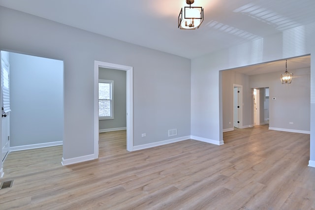 8004 S Ada St, Chicago, IL 60620 - spare room with a chandelier and light wood-style floors