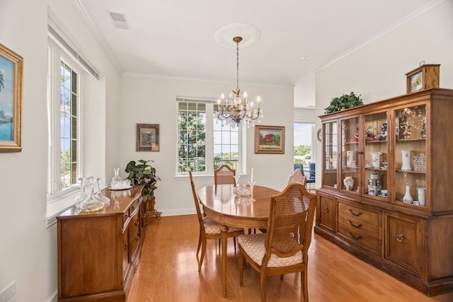 2660 Summit Dr Unit 302, Glenview, IL 60025 - dining space featuring a chandelier, healthy amount of natural light, light wood-type flooring, and ornamental molding
