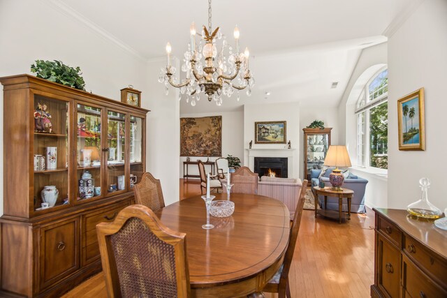2660 Summit Dr Unit 302, Glenview, IL 60025 - dining room with a lit fireplace, a chandelier, and light wood-style floors